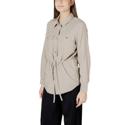 Womens beige button down drawstring blazer with long sleeves, two chest pockets, and a drawstring waist