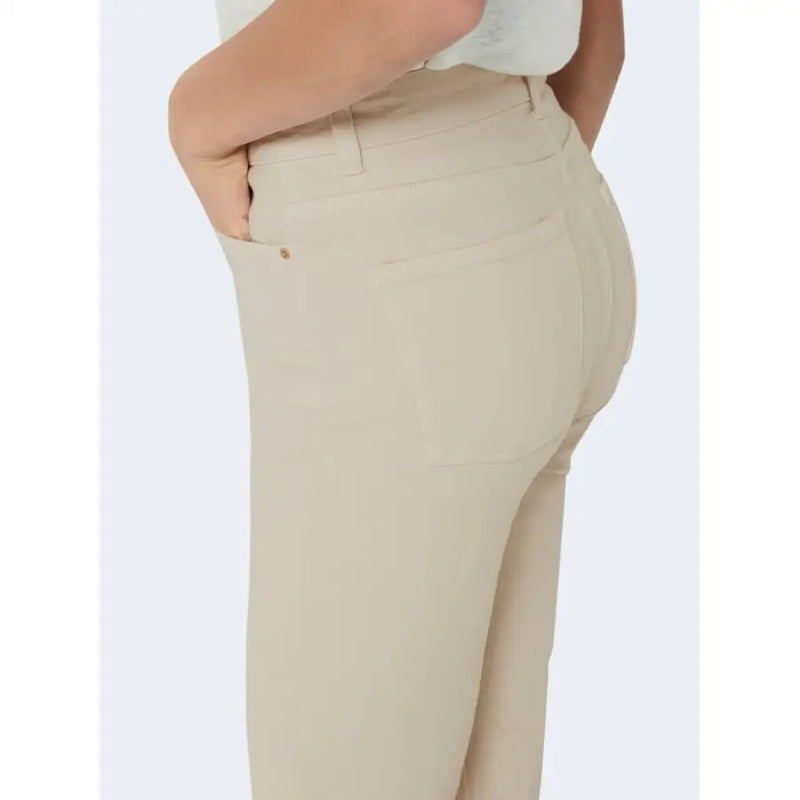 Jean beige pour femme avec poches, taille haute et coupe cintrée, orné de surpiqûres discrètes.