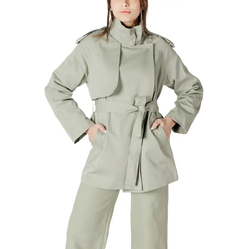 A sleek olive-green women’s belted trench coat blazer with structured shoulders and a fitted waist design