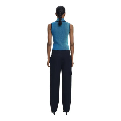 Women wearing a blue sleeveless top and dark blue cargo pants with front pockets