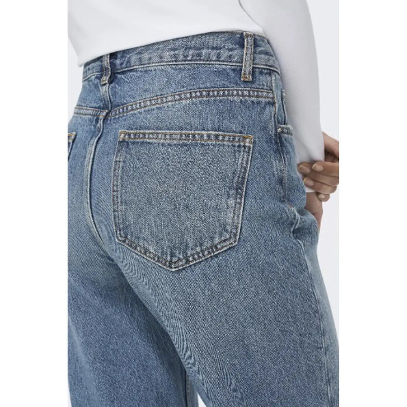 Back side of women’s blue jeans 100 percent cotton medium wash with classic pockets and contrasting stitching