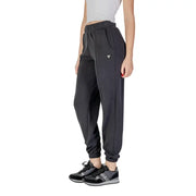Women’s dark grey athletic joggers with elastic cuffs and silver logo for Guess Active collection