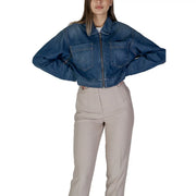 Women’s blue denim zip up blazer with two front pockets and zipper closure in cropped jacket style