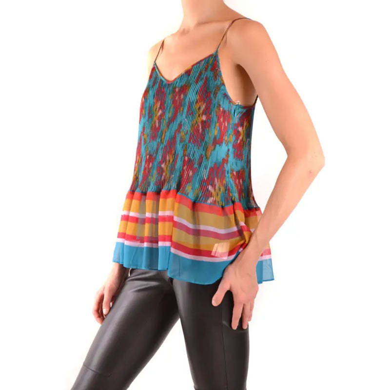 Women’s pleated camisole with vibrant multicolored abstract pattern and striped hem paired with black leather-look pants