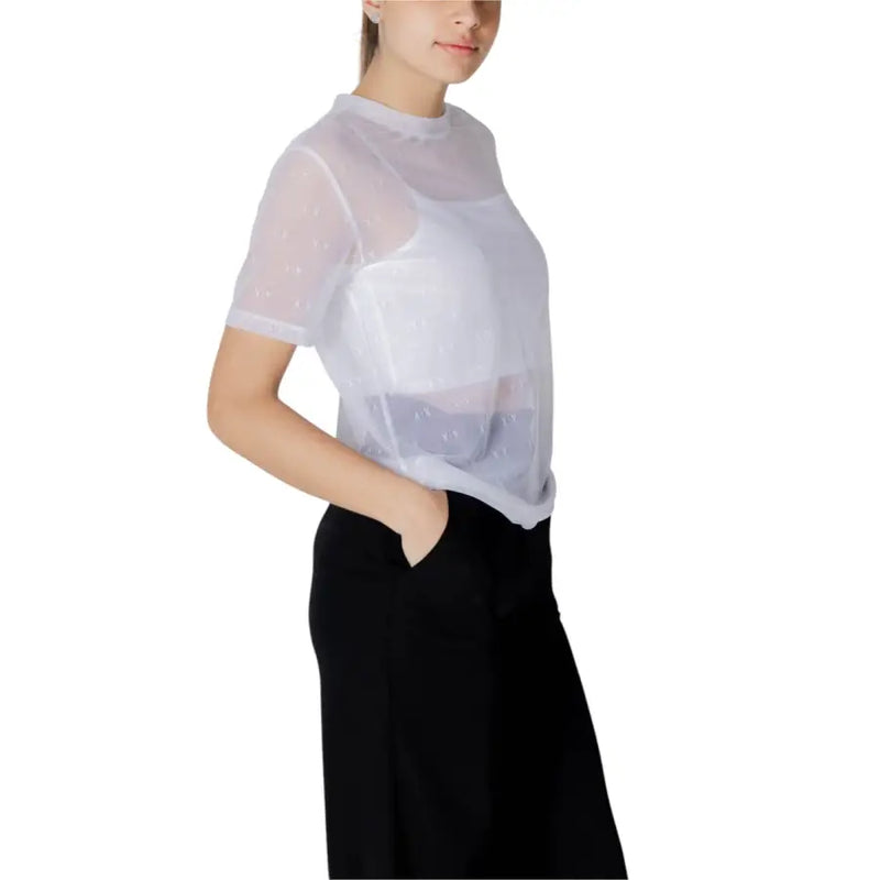 Women’s sheer white mesh top with short sleeves and high neckline worn over white tank for layered style