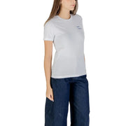Women wearing a white cotton short-sleeve round neck T-shirt with wide-leg blue denim pants