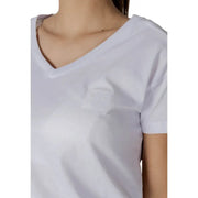 Womens white v neck t shirt made of soft fabric with a subtle embroidered smiley face patch on the chest
