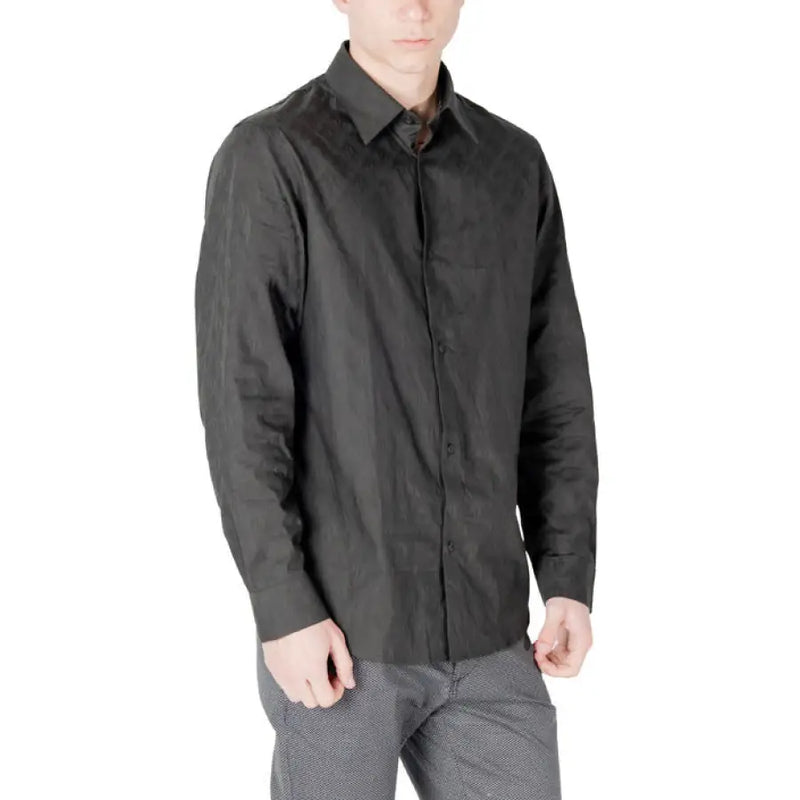 Dark wrinkled long-sleeved black button-down shirt suitable for formal and casual wear