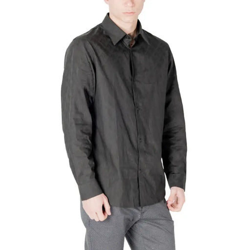 Dark wrinkled long-sleeved black button-down shirt suitable for formal and casual wear