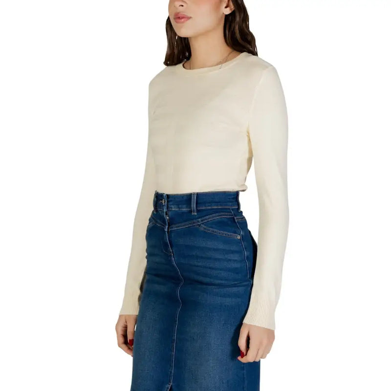 Cream-colored long-sleeved viscose knit top with a round neckline ideal for casual and formal wear