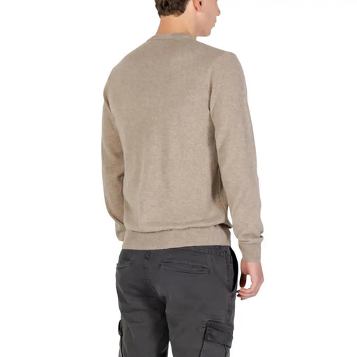 Beige crew neck sweater with ribbed cuffs and hem, likely made of cotton or a similar soft fabric.