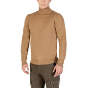 Camel-colored turtleneck sweater with ribbed cuffs and hem, likely made of cotton or a similar soft material.