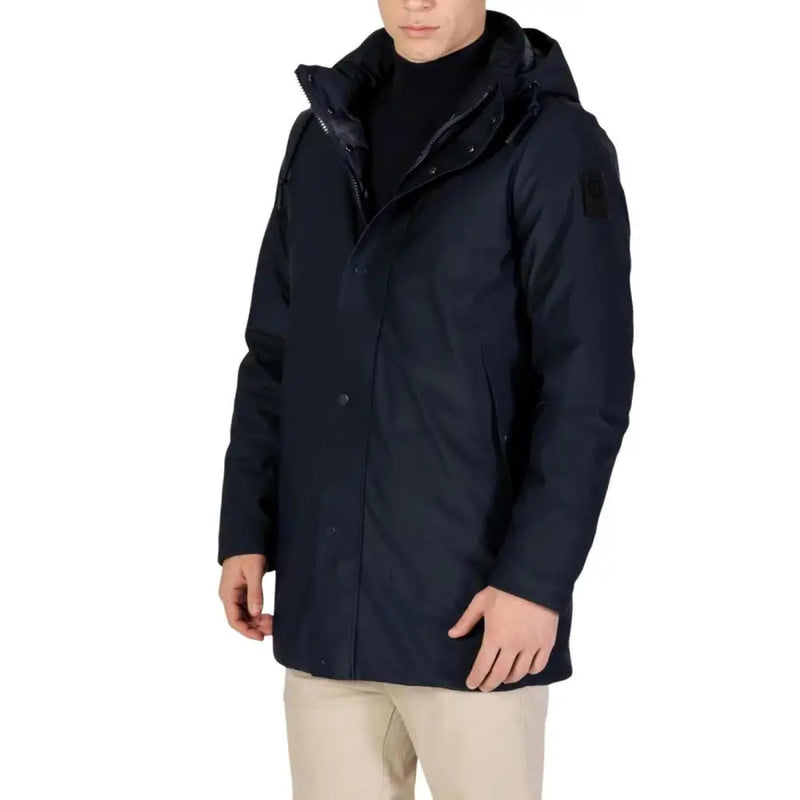 Navy blue down jacket with hood and black fur trim, water-resistant material.
